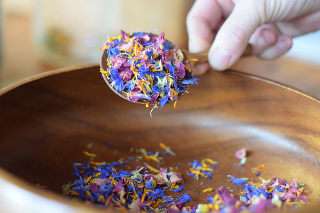 Dried herbs in a wooden bowl — ingredients used in traditional Chinese herbal formulas