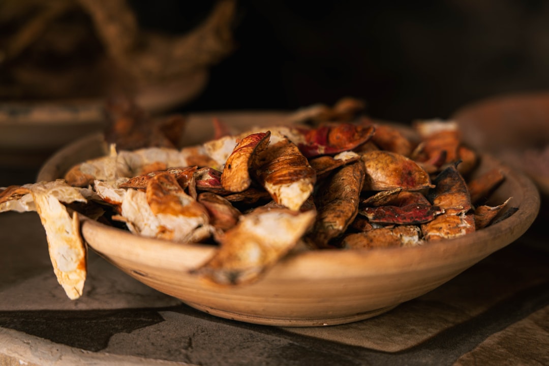 dried medicinal herbs in a wooden bowl for Chinese formulas