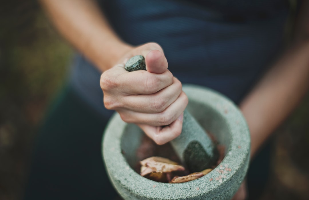 Preparing dried herbs by hand, reflecting traditional saw palmetto preparation