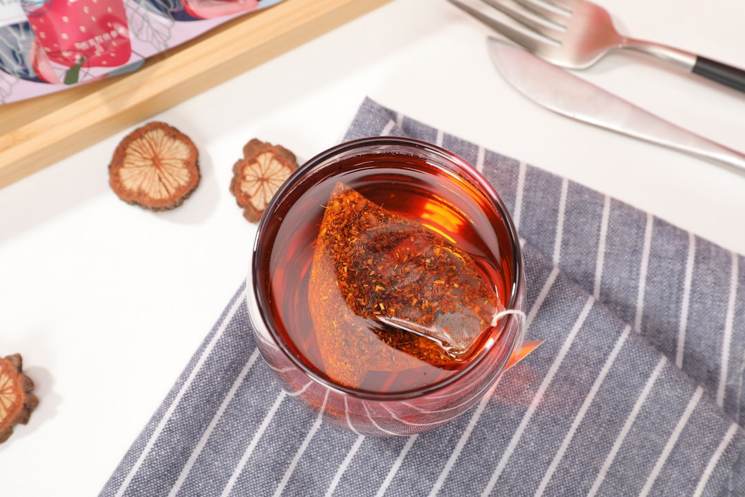 Glass jar holding a dark bark infusion, one way to take wild cherry bark