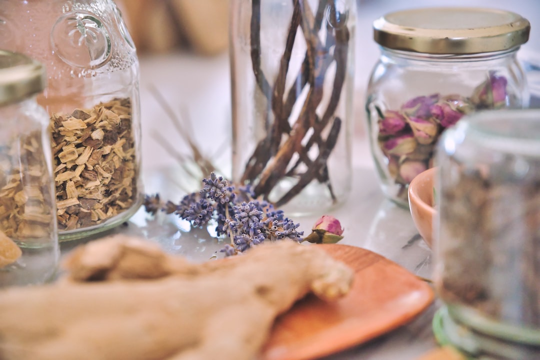 Dried medicinal roots and herbs stored in glass apothecary jars