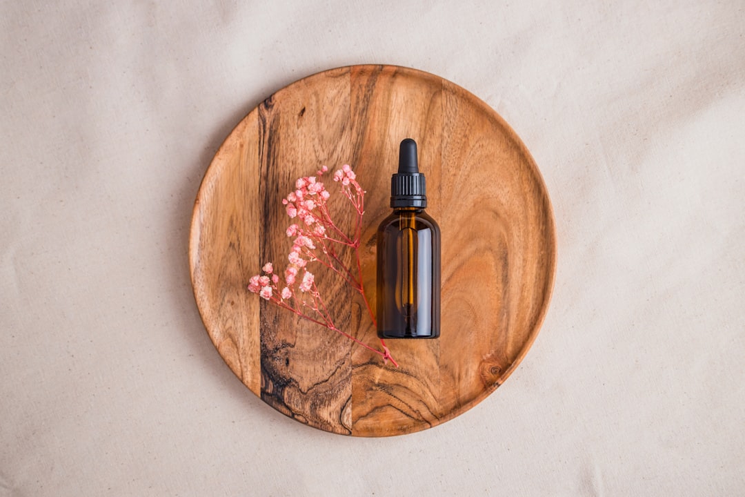 Amber dropper bottle of tincture on a wooden surface