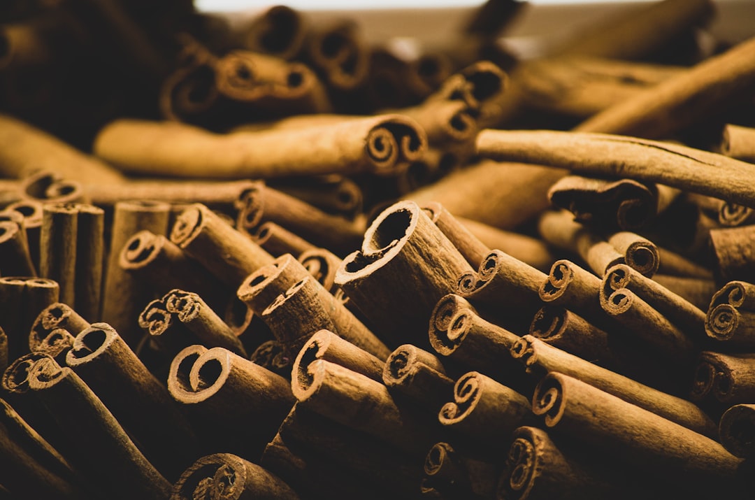 Loose cinnamon bark pieces on a wooden surface