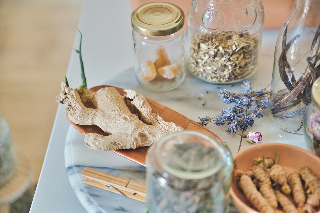Dried roots and herbs in glass jars on a table