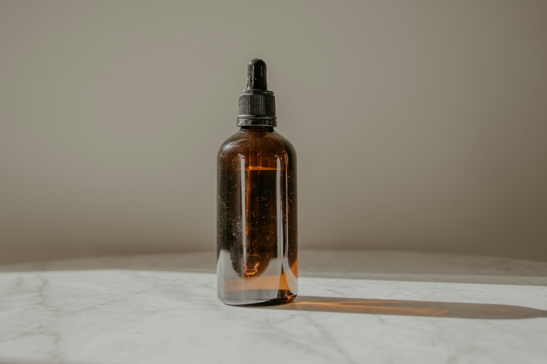 Amber glass dropper bottle of mushroom tincture on a marble table